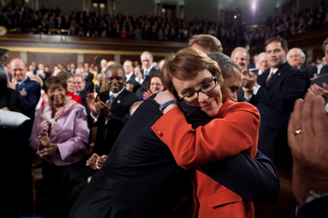 President Barack Obama greets Rep. Gabrielle Giffords, D-Ariz., as he arrives on the floor of the House Chamber to deliver the State of the Union address at the U.S. Capitol in Washington, D.C., Jan. 24, 2012. (Official White House Photo by Pete Souza) 2012_01_p012412ps-0426
