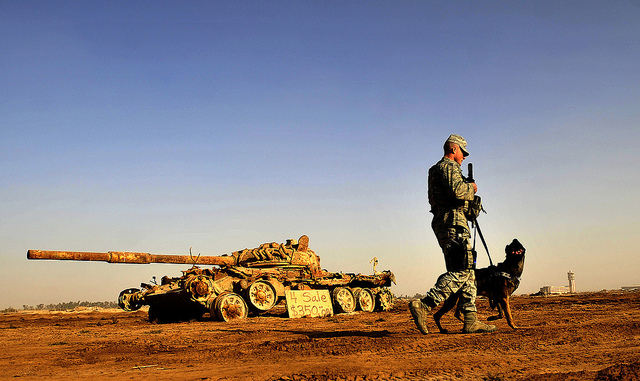 Senior Airman Stephen Hanks and Geri, a patrol and explosive detector dog, both with the 447th Expeditionary Security Forces Squadron, patrol the perimeter of Sather Air Base on Dec. 11, 2011, in Baghdad, Iraq. (U.S. Air Force photo by Master Sgt. Cecilio Ricardo) 2012_08_Air-Force-4